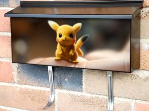 A Small Pikachu Sitting On Top Of A Finger Townhouse Mailbox Cover